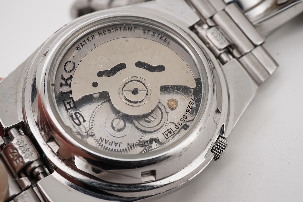 Two gentleman's recent stainless steel Seiko 5 automatic day/date wrist watches, one with black dial, the other blue dial, case diameters 36mm, both on stainless steel Seiko straps (one a.f.). no boxes or paperwork.